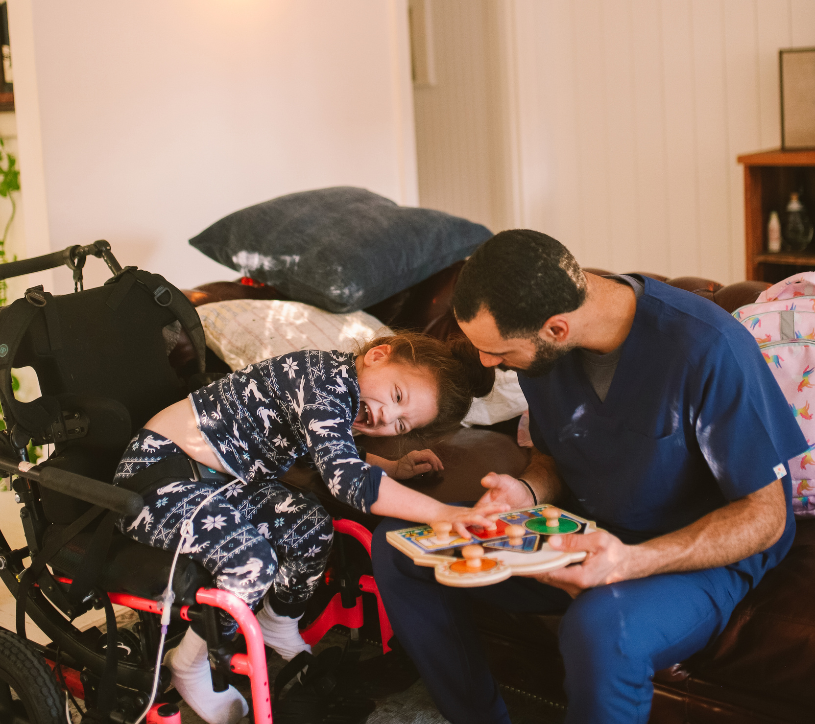 Home Nurse Playing with a Child with Cerebral Palsy 